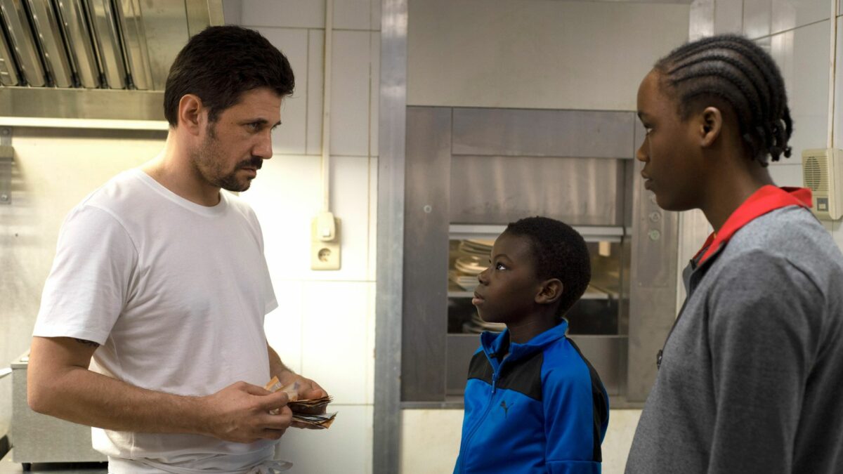 Kuchnia restauracji, pracownik wypaca zarobek dla dwójki młodych ludzi.