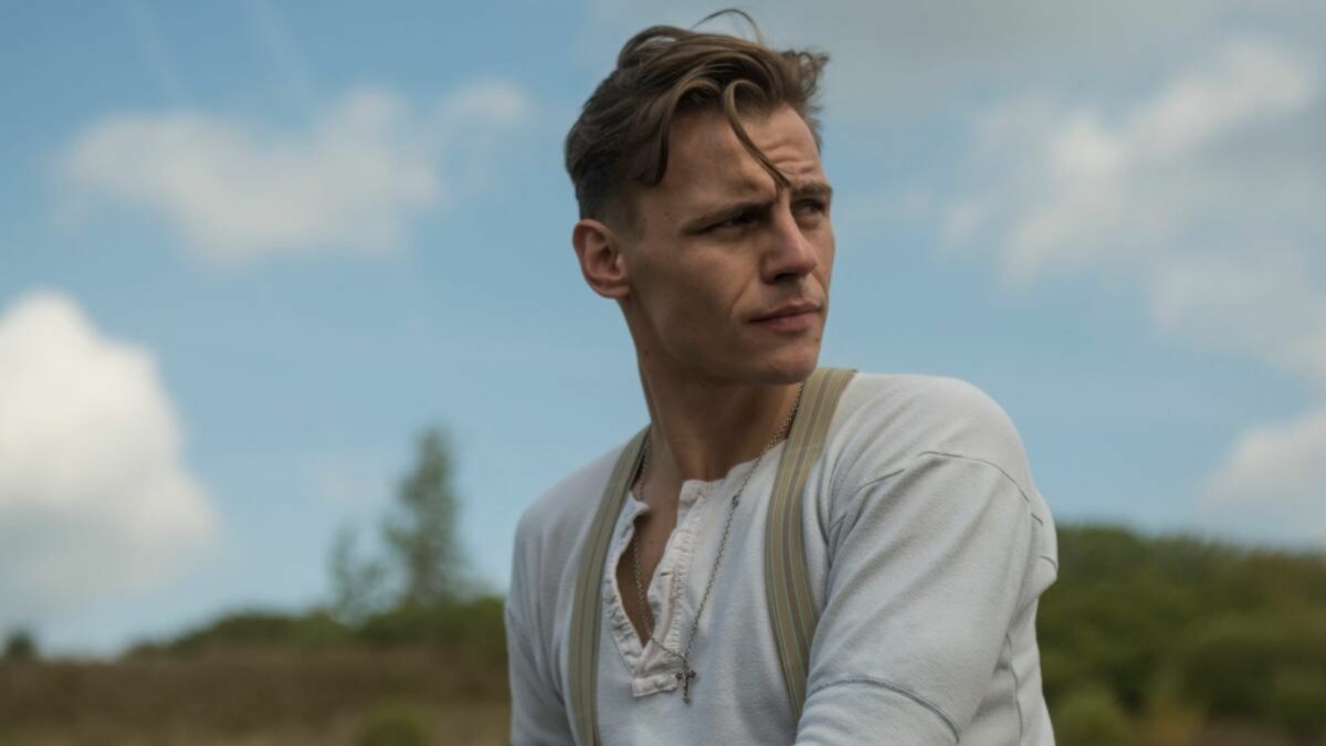 Młody Pilecki na tle przyrody.