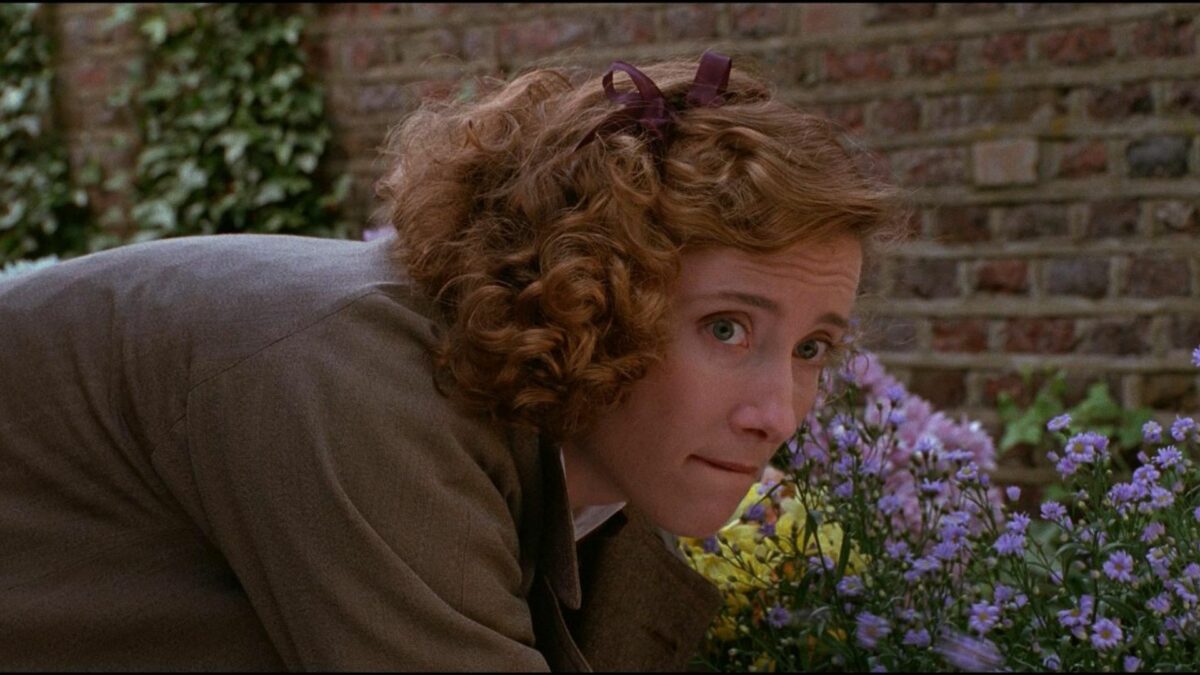 Kobieta wykonująca pracę przy ogrodowych kwiatkach.