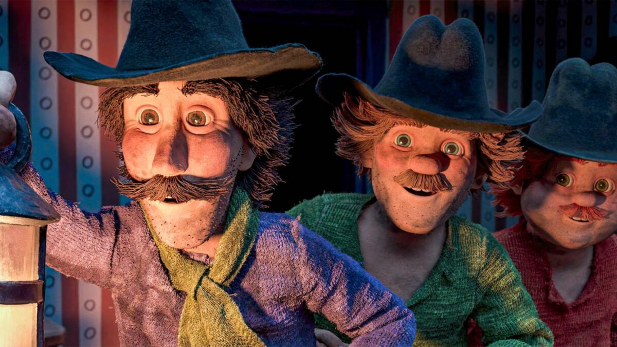 Główni bohaterowie bajki w ciemnym pomieszczeniu przy lampie naftowej.