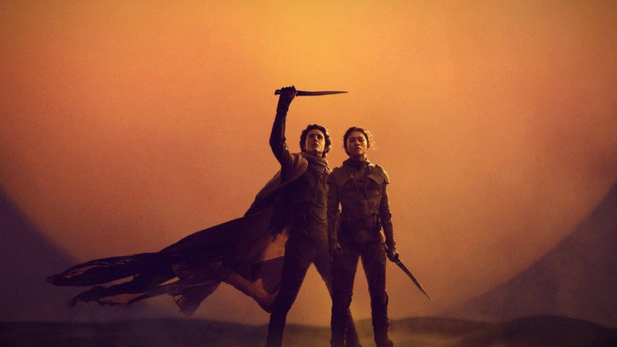 Chłopak w towarzystwie dziewczyny na pustyni na tle wschodzącej planety.