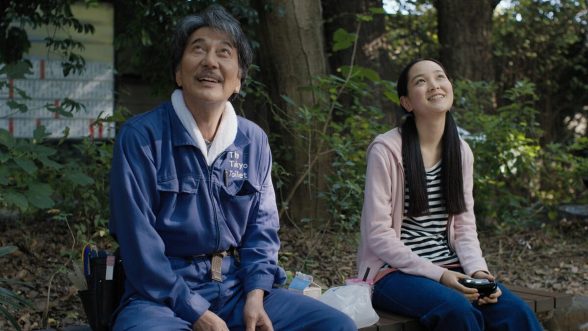 Zadowolny mężczyzna siedzi w parku na ławce w towarzystwie dziewczyny.