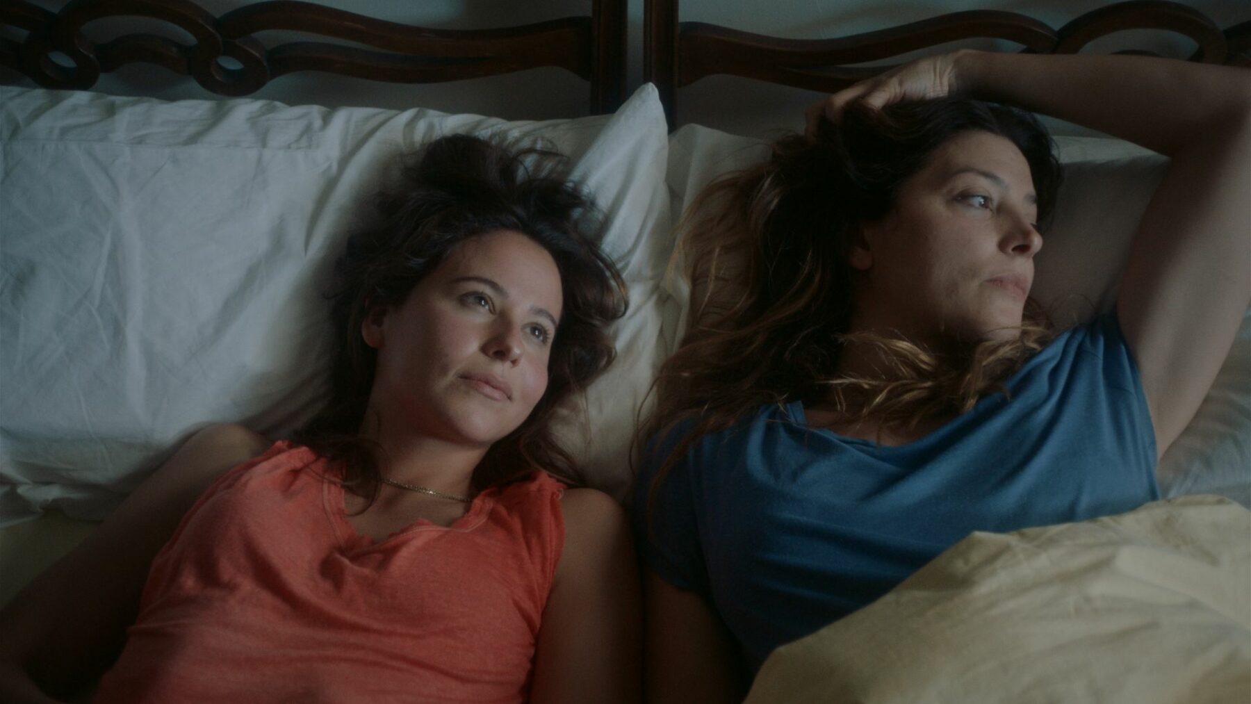 Kadr przedstawia dwie kobiety leżące w łóżku.