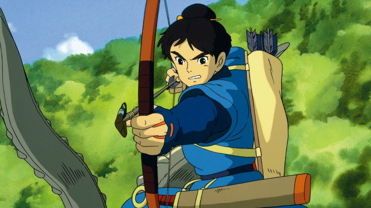 Młody łucznik strzelający do celu.