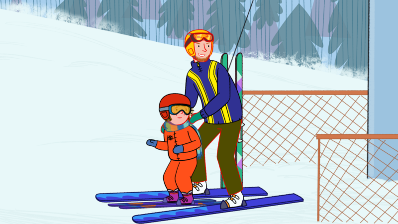 Mała dziewczynka z tatą na nartach.