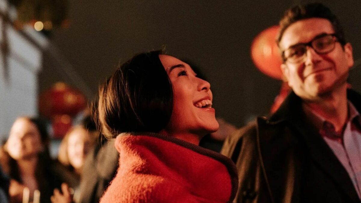 Kobieta wpatrzona w ciemne niebo a w tle widać mężczyznę.