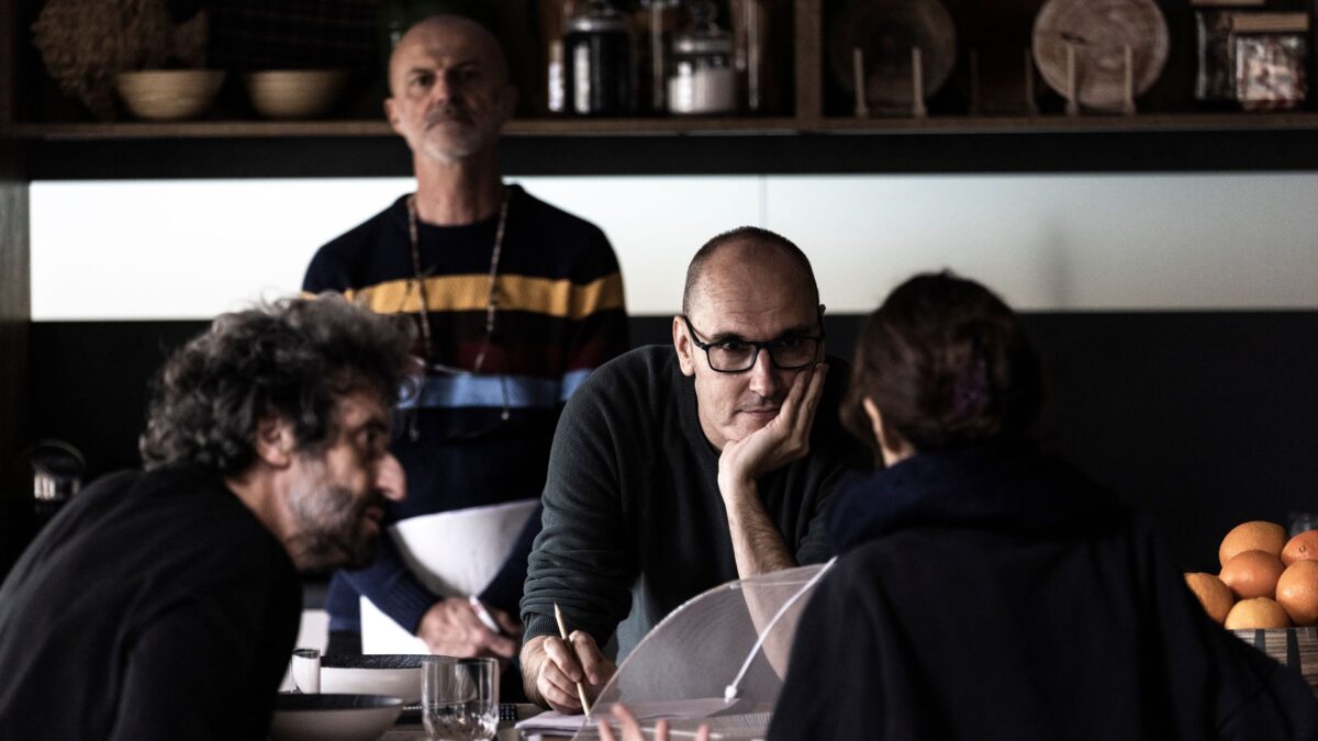 Cztery osoby przy stole pracują nad dokumentami.